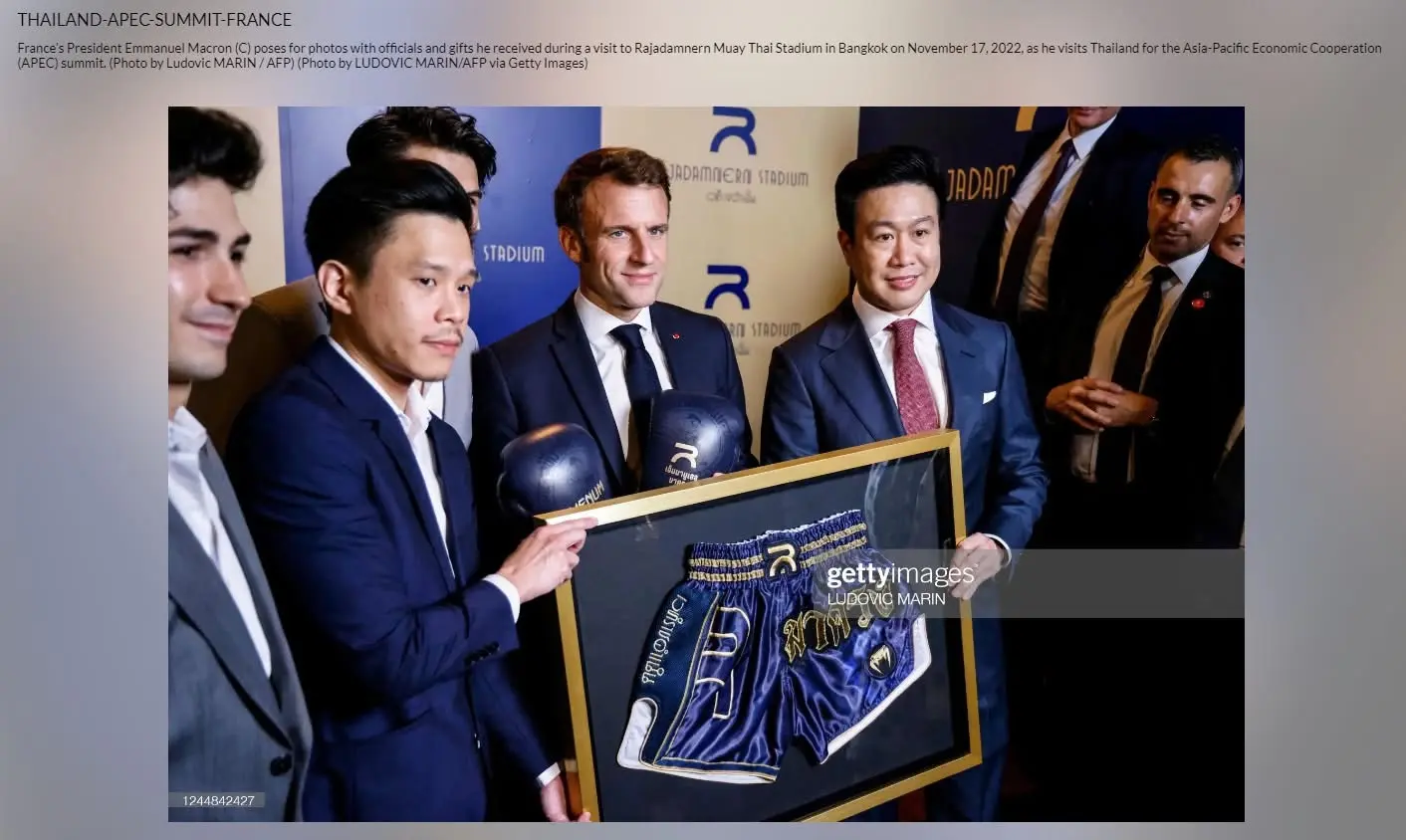 President Macron receiving framed Muay Thai shorts at Rajadamnern Stadium